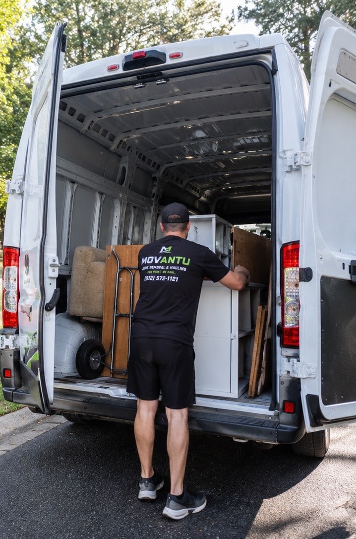 MOVANTU team loading furniture and appliances into the branded ProMaster van